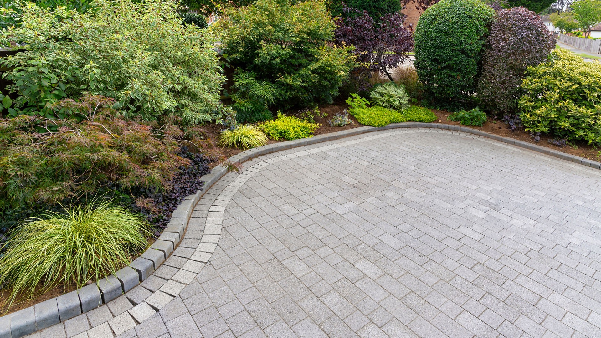 Tarmac patio area in a garden setting